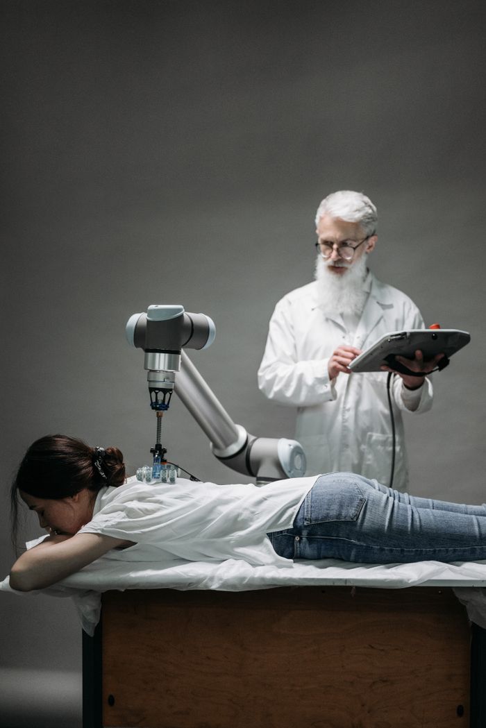 Crafting Captivating Headlines: Your awesome post title goes here A scientist uses a robotic device for advanced therapy on a woman in a lab setting.